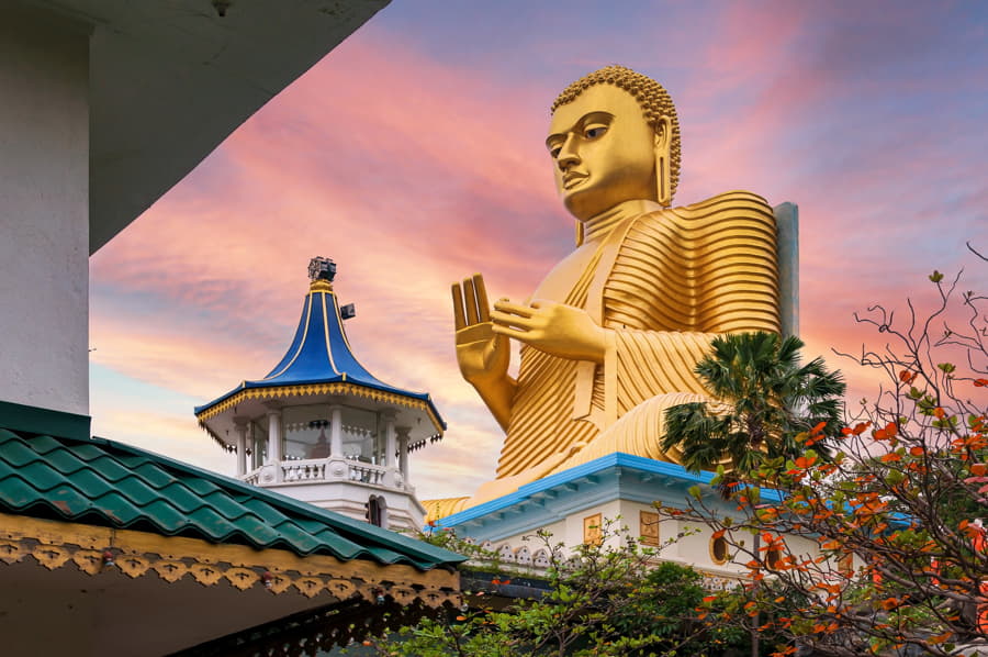 Estatua dorada de Buda en el templo de Dambulla, Sri Lanka, al atardecer